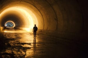 Subway tunnel construction with silhouette of walking worker