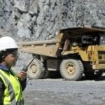 woman on the mining site with the dump truck